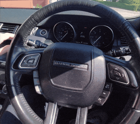 Driver pressing a secret button sequence on the steering wheel of a car with an anti theft immobiliser