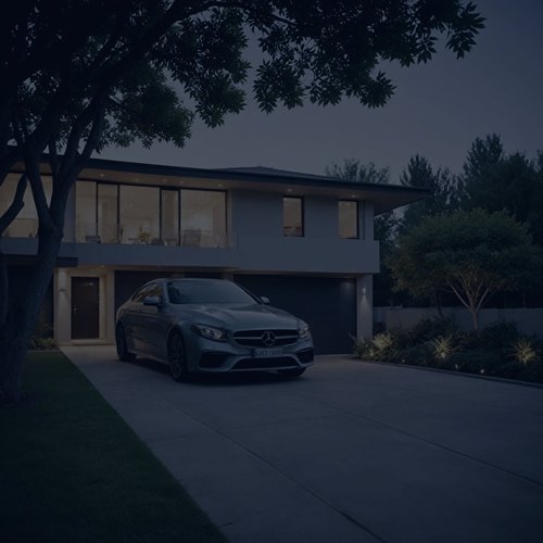 A keyless car parked on a house driveway at night